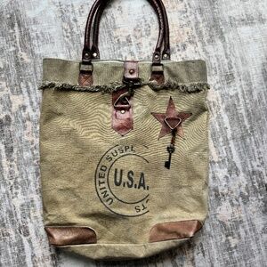 Mona B upcycled canvas tote bag featuring a "U.S.A." graphic, brown faux-leather